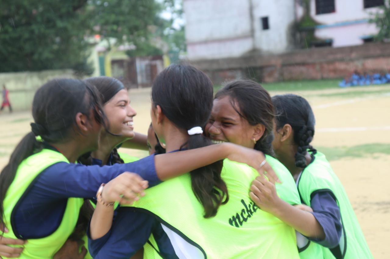 Girls embracing during a team sports session