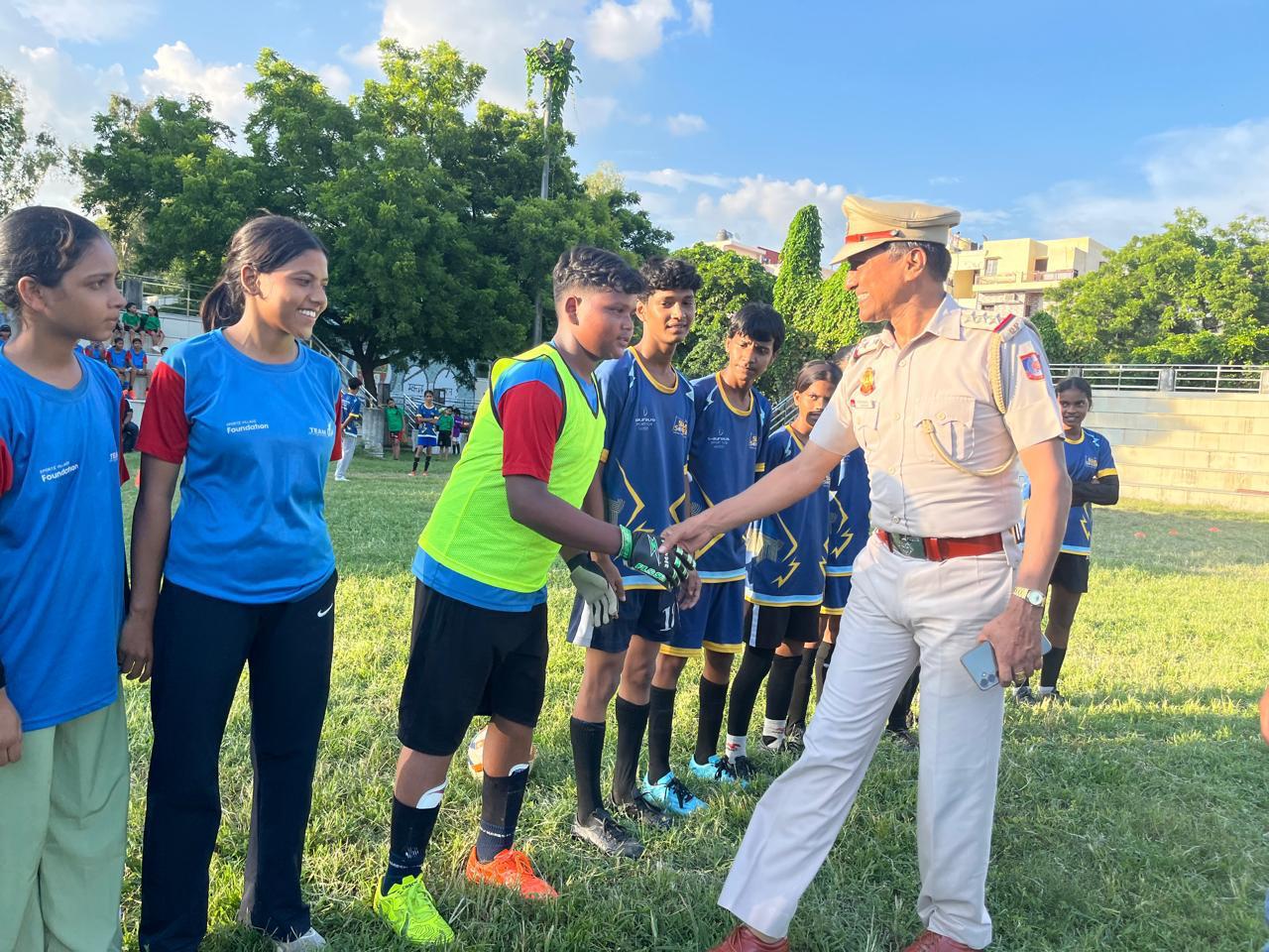 Young football players speaking with a community leader