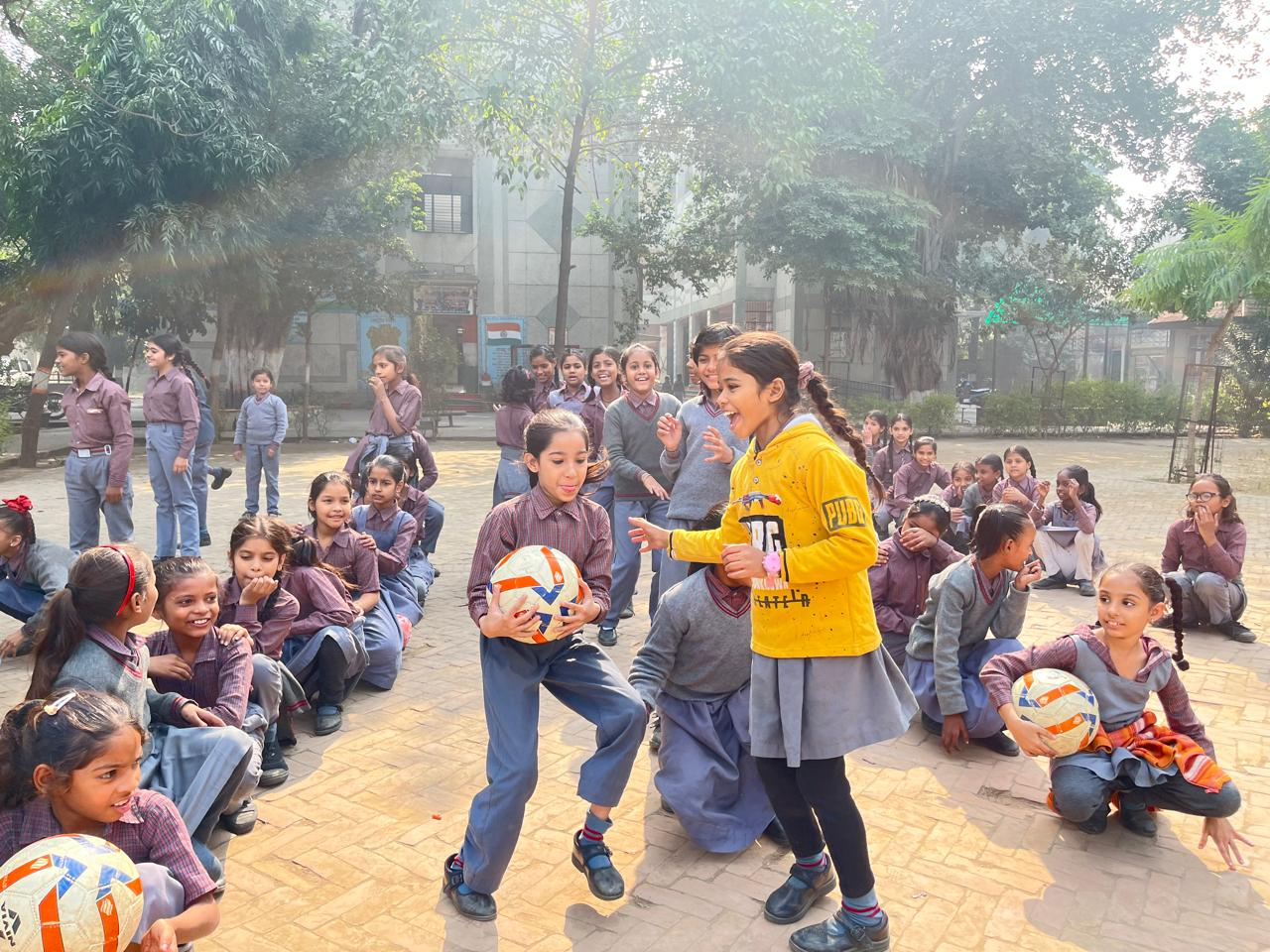Girls building confidence through a football activity